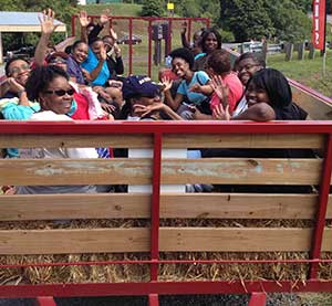 Apple pickers coming back from the orchard on the wagon ride