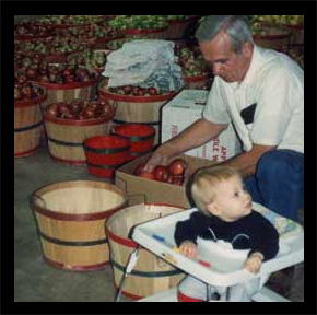 Marvin Pritchett boxing apples with grandson Zach at his side