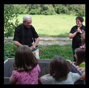 Marvin Pritchett owner showing young apple pickers the ropes!