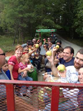 U-Pick wagon rides families back at the Apple Barn after a picking apples in the
							 orchard in Ellijay, Ga